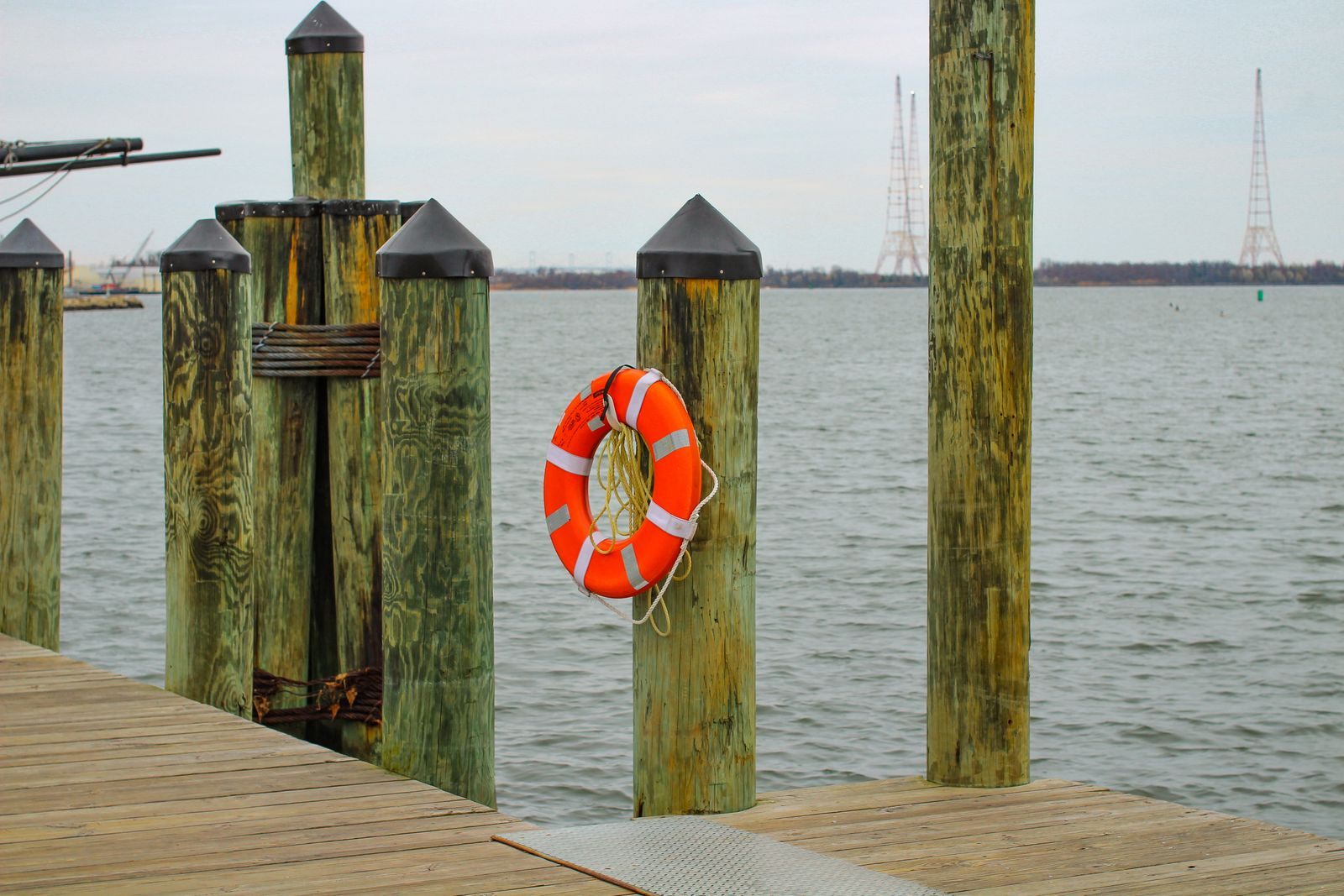 Wooden dock with an orange life ring on the water at Annapolis, a port on Chesapeake Bay cruises