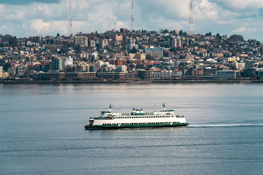 Washington State ferry crossing Puget Sound in front of a hillside town